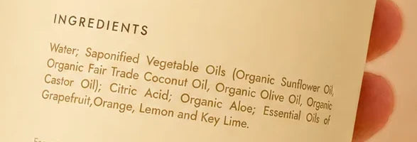 The ingredient panel on a Pura Vitalia bottle: water, saponified vegetable oils, citric acid, organic aloe and essential oils